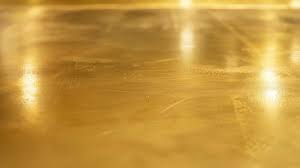 Smooth surface of brushed brass metal.